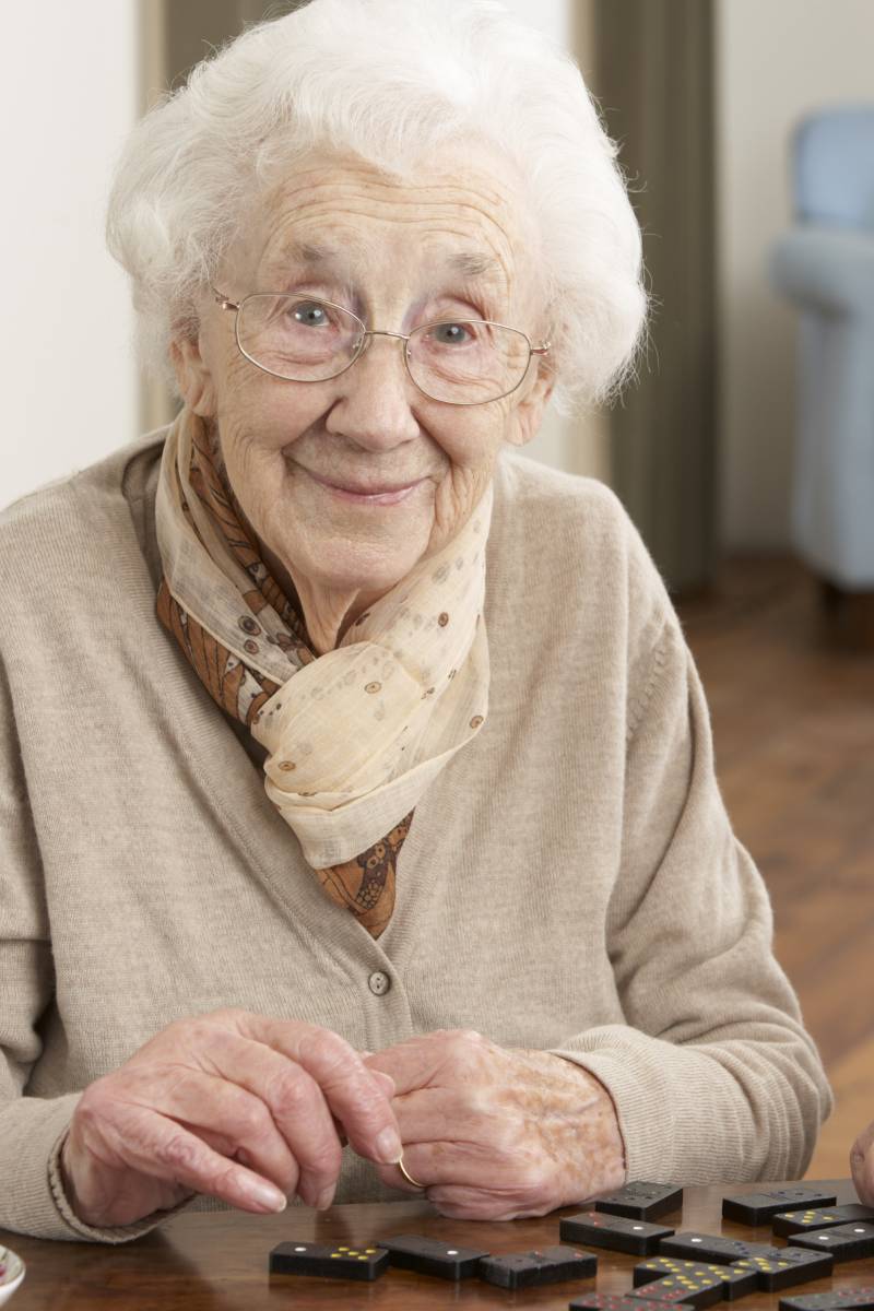 Mujer mayor jugando domino